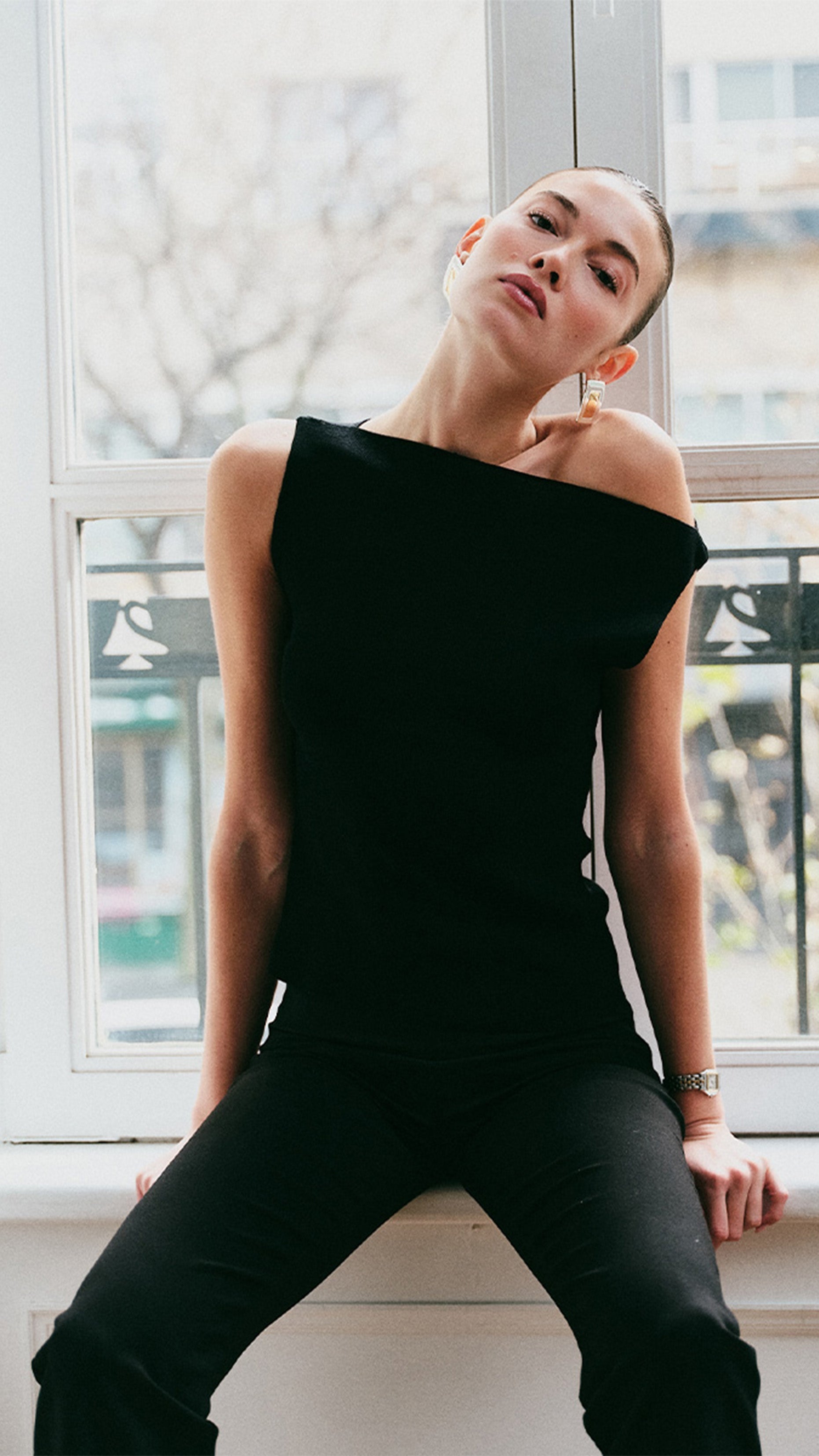 model wearing black asymmetrical top and pants 