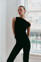 Model wearing the Arue Studios Balance Knit Sweater, a soft women’s knit top designed with a minimal silhouette and lightweight feel.
