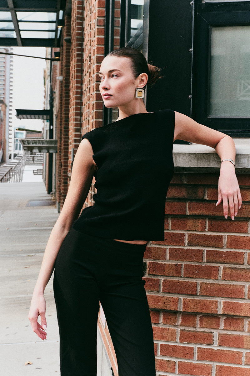 Model wearing the Arue Studios Balance Knit Sweater, a soft women’s knit top designed with a minimal silhouette and lightweight feel.
