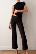 Model wearing a black outfit against a plain background