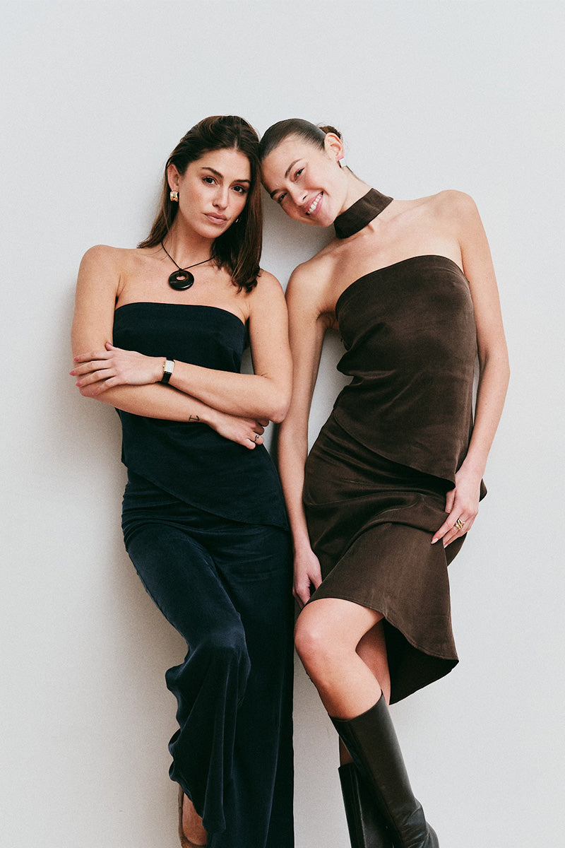 Models in strapless dresses posing against a plain background