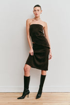 Model wearing a brown strapless top and brown skirt 