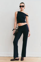 Model wearing the Still Micromodal Pant in navy, a soft low-rise straight-leg pant styled with matching top and leather loafers.

