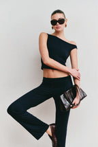 Model wearing the Still Micromodal Pant in navy, a soft low-rise straight-leg pant styled with matching top and leather loafers.
