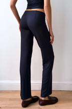 Model wearing the Still Micromodal Pant in navy, a soft low-rise straight-leg pant styled with matching top and leather loafers.