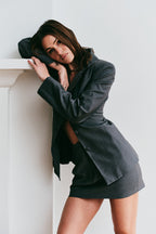 Model wearing a gray skirt suit set 