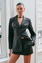 Model wearing a gray skirt suit set 