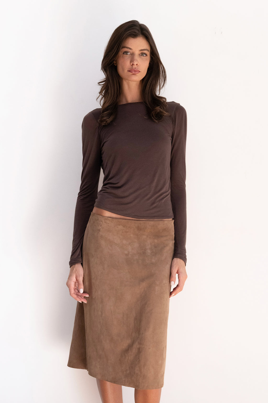 Model wearing the espresso Twist Top with a boat neckline, long sleeves, and a softly fitted silhouette.
