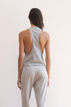 Model wearing a light heather gray tank top and matching light heather gray jogger pants