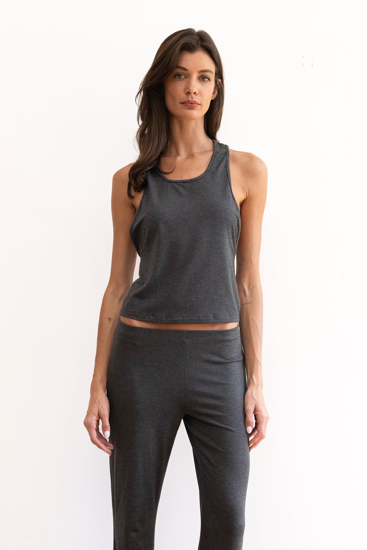 Model wearing a charcoal tank top and matching charcoal pants