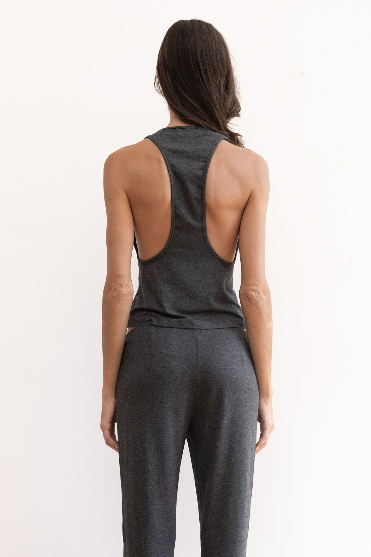 Model wearing a charcoal tank top and matching charcoal pants