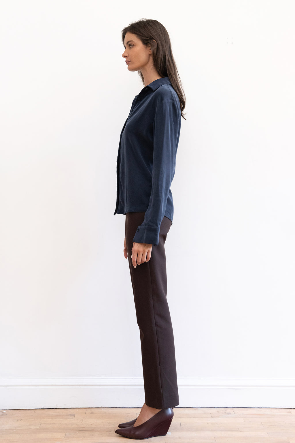 Model wearing espresso contour pants and navy cupro synched waist button down shirt