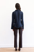 Model wearing espresso contour pants and navy cupro synched waist button down shirt