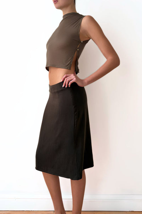 Model wearing a taupe sleeveless top and brown skirt 