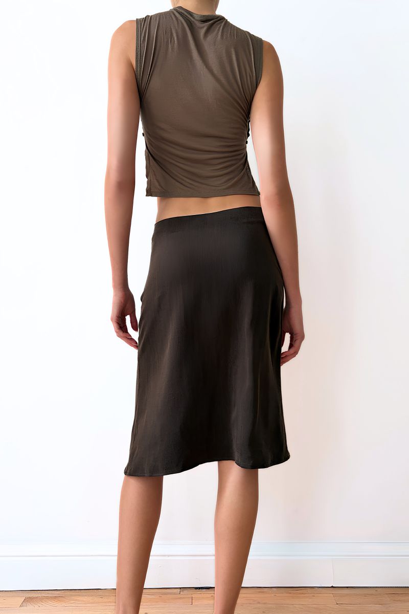 Model wearing a taupe sleeveless top and brown skirt 