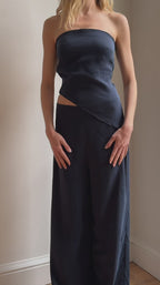 Model wearing the Arue Studios Strapless Drape Top, a minimal strapless women’s top with soft draping and a refined fit.
