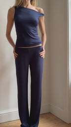 Model wearing the Still Micromodal Pant in navy, a soft low-rise straight-leg pant styled with matching top and leather loafers.
